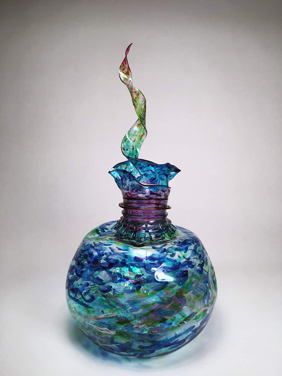 A glass sculpture in the shape of a vase.